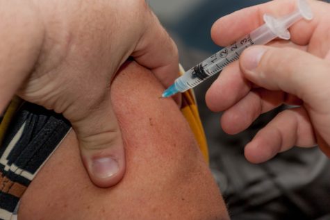 Person receiving vaccination injection