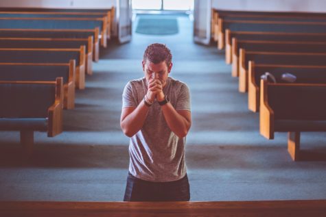 Man praying inside church