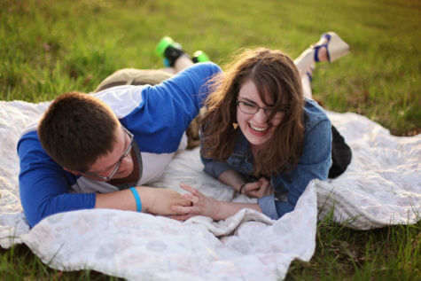 Couple on picnic blanket laughing
