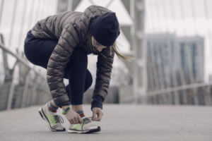 Woman tying shoes before running