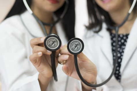 Doctors holding stethoscopes