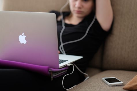 Teen using computer, smartphone