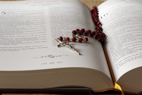 Rosary beads and cross on Bible