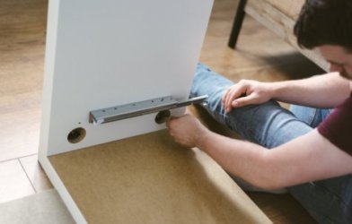 Man putting cabinet together DIY project