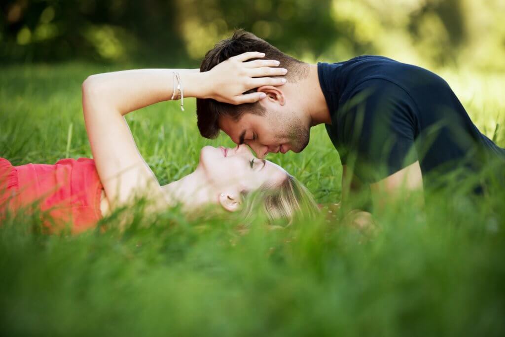 Couple laying in grass