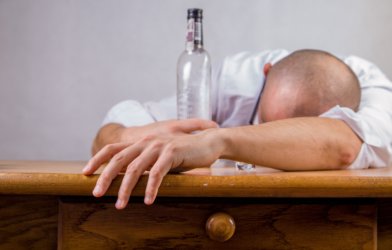 Hungover man with alcohol