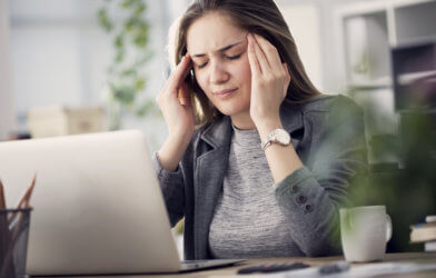 Stressed or sick woman in pain or suffering from headache