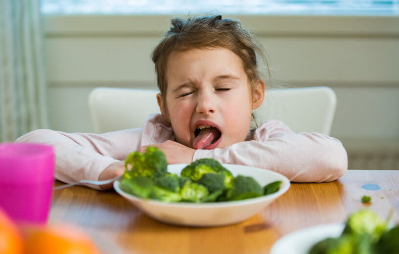 Little girl hates vegetables, broccoli