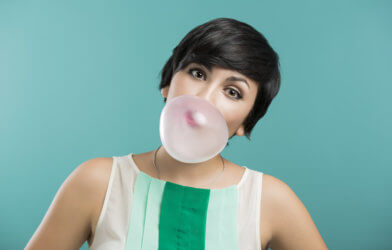 Woman blowing bubble with gum