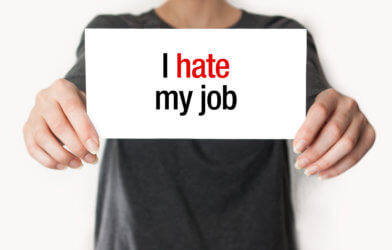 Woman holding "I Hate My Job" sign