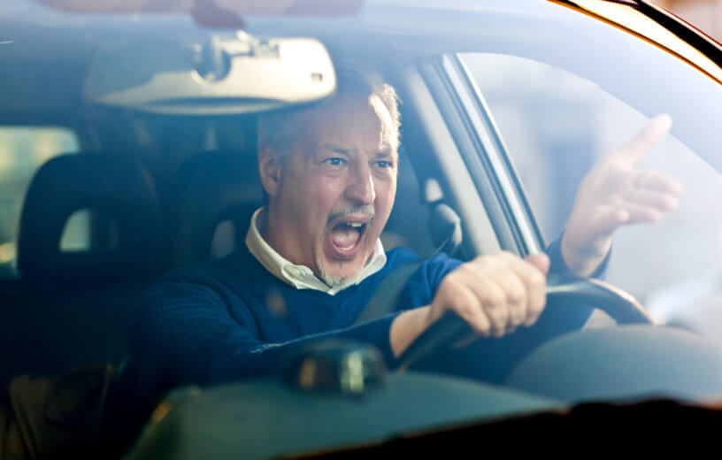 Angry, stressed driver having bad commute, road rage