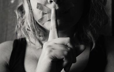 Sad, scared woman self-silencing