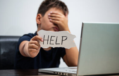 Boy being cyberbullied or experiencing digital dating abuse