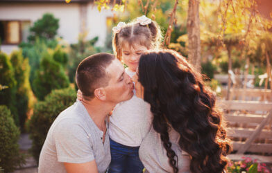 Parents kissing in front of child