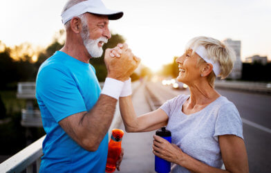 Happy older senior couple exercising or working out