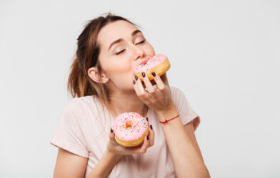 Skinny woman eating donuts