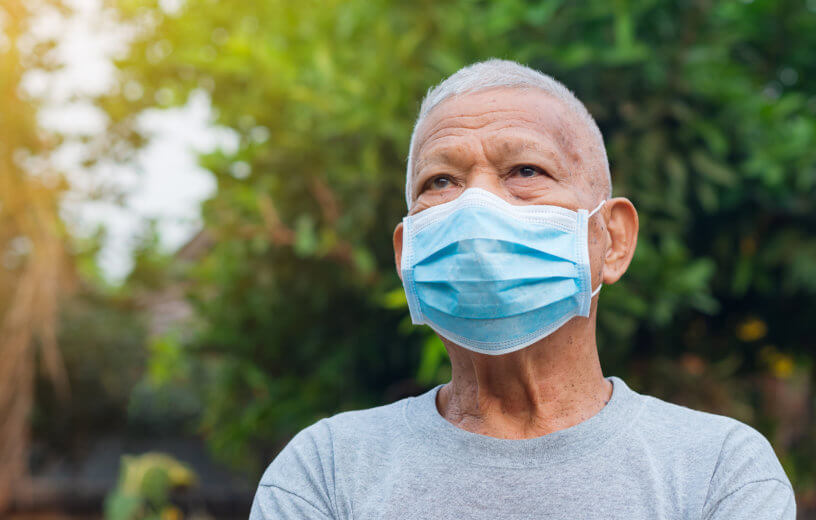 Older man wearing face mask during COVID-19 / coronavirus pandemic