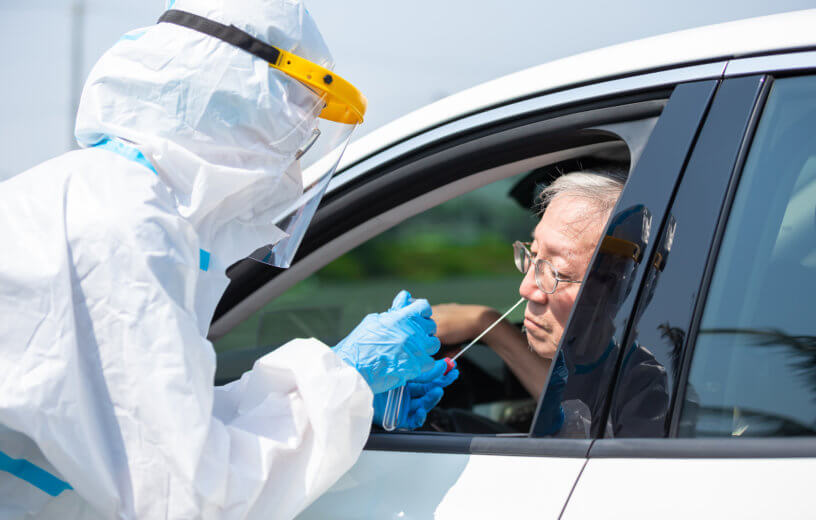 Man getting coronavirus / covid-19 test in his car