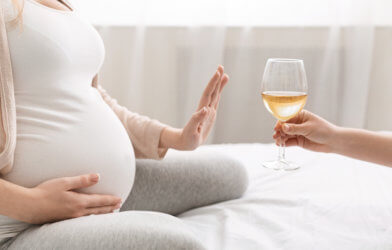 Pregnant woman declines glass of wine, alcohol