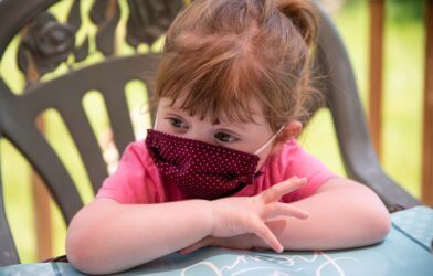 Little girl wearing face mask during coronavirus / COVID-19 outbreak