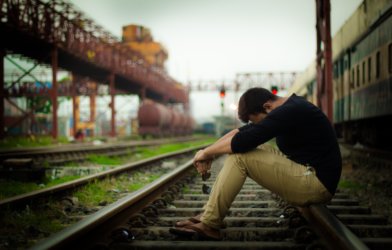Teen or young adult upset, alone on train tracks, possibly suicidal