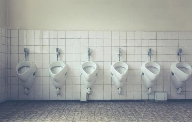 Row of urinals, toilets in bathroom