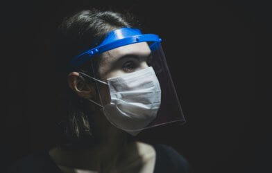 Woman wearing face shield and face mask during coronavirus pandemic