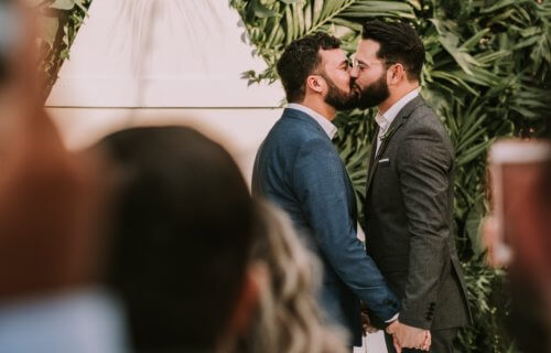 Gay couple kissing at wedding