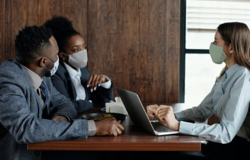 People wearing surgical face masks during meeting