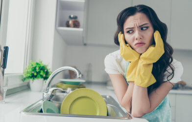 Woman frustrated about washing dishes