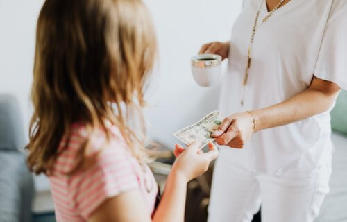Mother gives child money for allowance