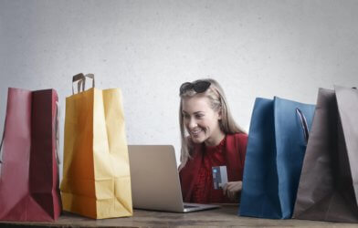 Shopaholic: Woman online shopping with shopping bags
