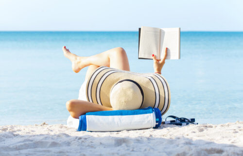 Woman reading book on the beach