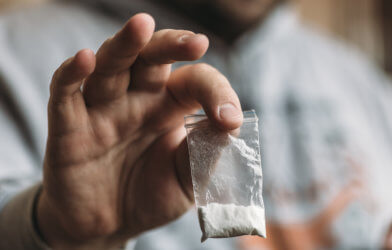 Man holding bag of cocaine