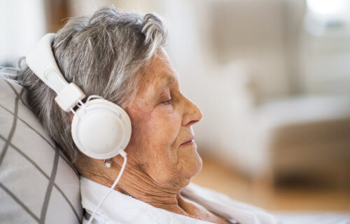 Woman listening to music while lying down