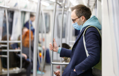 Man wearing face mask on subway