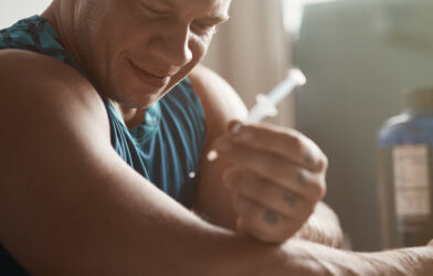 Man making anabolic steroid injection